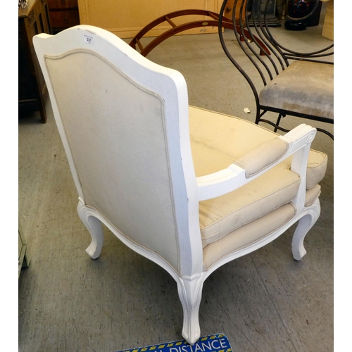 237 - A modern white painted showwood framed open arm chair, upholstered in cream coloured fabric, raised ... 