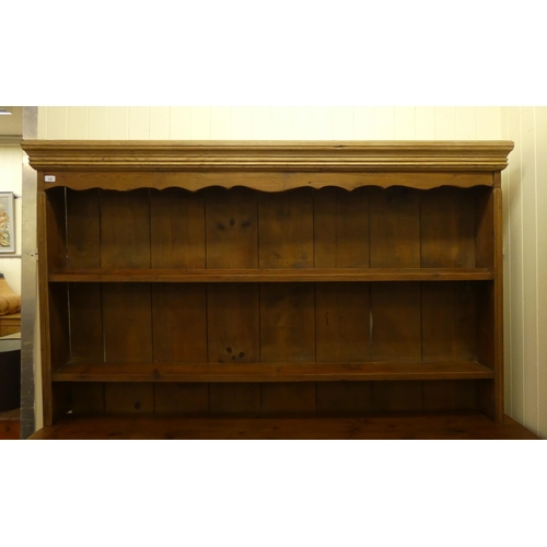 246 - A late 19th/early 20thC rustically constructed pine, two-part dresser, the superstructure with two o... 