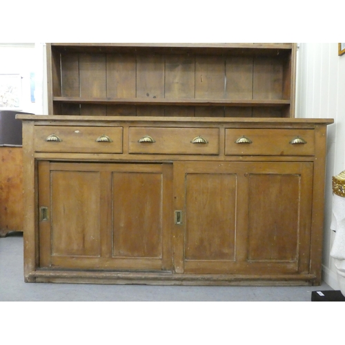 246 - A late 19th/early 20thC rustically constructed pine, two-part dresser, the superstructure with two o... 