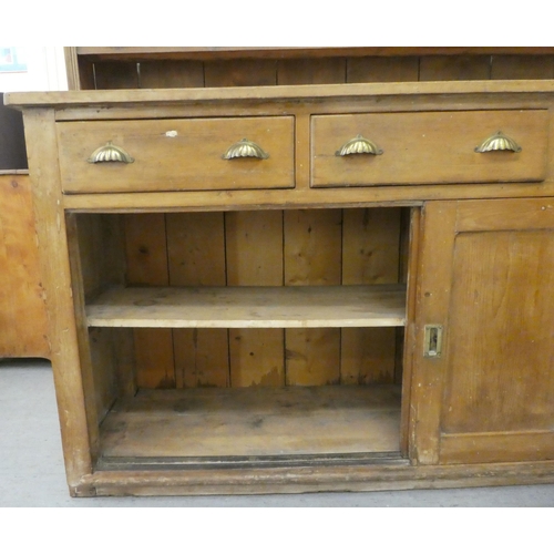 246 - A late 19th/early 20thC rustically constructed pine, two-part dresser, the superstructure with two o... 