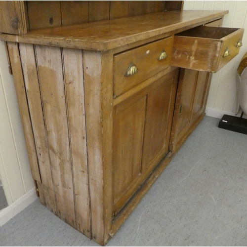 246 - A late 19th/early 20thC rustically constructed pine, two-part dresser, the superstructure with two o... 