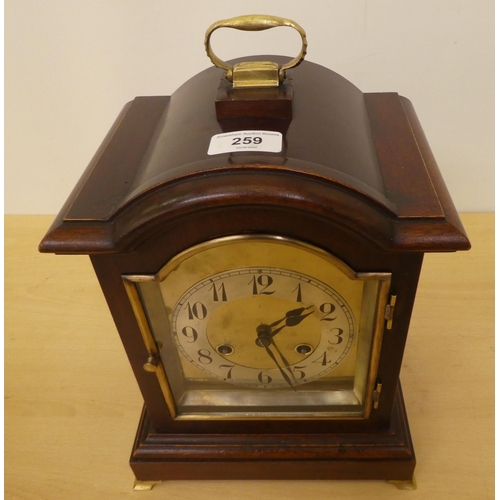 259 - An Edwardian mahogany cased mantel clock; the 8 day movement faced by an Arabic dial  12