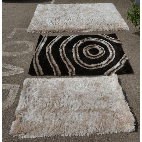 268 - Various shag pile design rugs, in different colours  largest 66