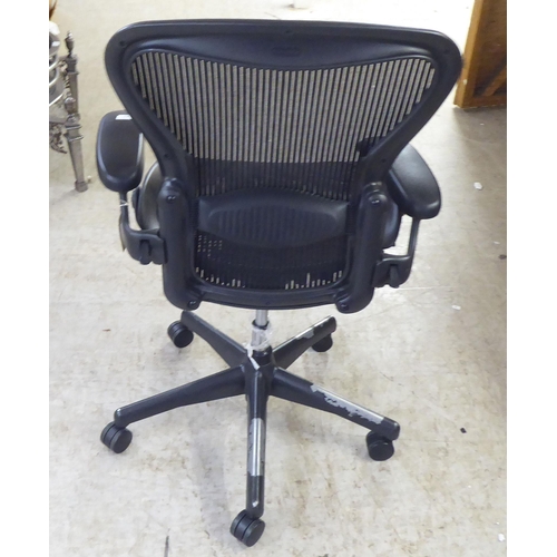 27 - A Herman Miller Aeron design, swivel office chair, raised on casters