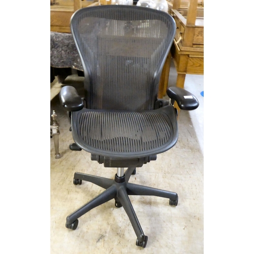 276 - A Herman Miller Aeron design swivel office chair, raised on casters