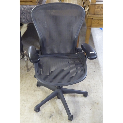 276 - A Herman Miller Aeron design swivel office chair, raised on casters