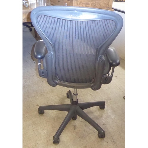 276 - A Herman Miller Aeron design swivel office chair, raised on casters