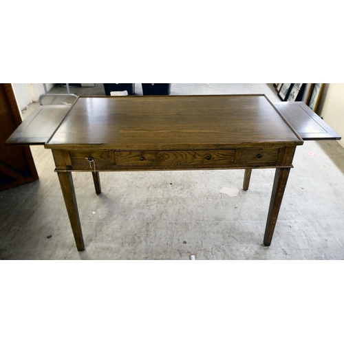 277 - A modern OKA oak desk with three drawers, raised on square, tapered legs  31