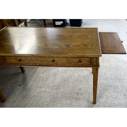 279 - A modern OKA oak desk with three drawers, raised on square, tapered legs  31