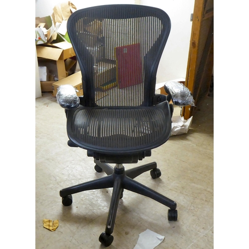 280 - A Herman Miller Aeron design swivel office chair, raised on casters