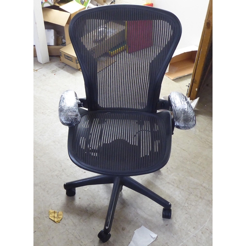 280 - A Herman Miller Aeron design swivel office chair, raised on casters