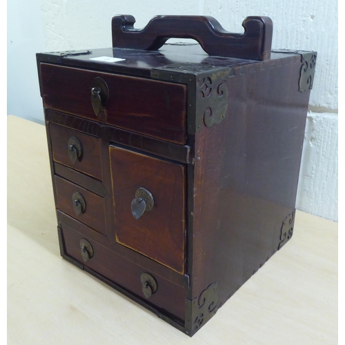 3 - A 20thC Chinese lacquered elm medicine chest with five drawers, on a plinth  12