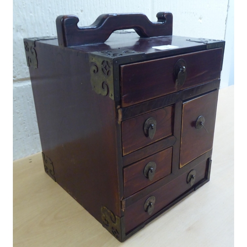 3 - A 20thC Chinese lacquered elm medicine chest with five drawers, on a plinth  12