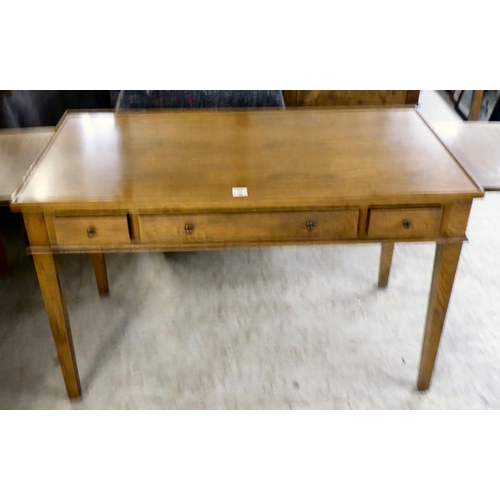 32 - A modern OKA oak desk with three drawers, raised on square, tapered legs  31