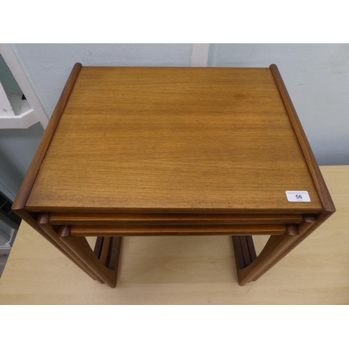 56 - A nesting set of three 20thC teak coffee tables, each raised on block legs  largest 19