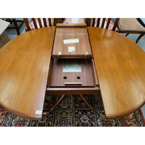 58 - A mid 20thC Stag teak dining table, raised on splayed legs  30