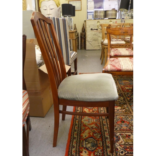 58 - A mid 20thC Stag teak dining table, raised on splayed legs  30