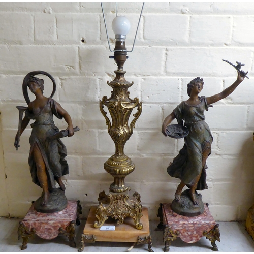 67 - A mixed lot: to include a pair of late Victorian spelter figures, scantily clad women, each on a mar... 