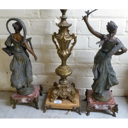 67 - A mixed lot: to include a pair of late Victorian spelter figures, scantily clad women, each on a mar... 