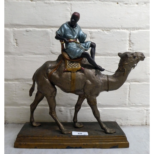 68 - A late Victorian painted spelter model, a man riding a camel  12