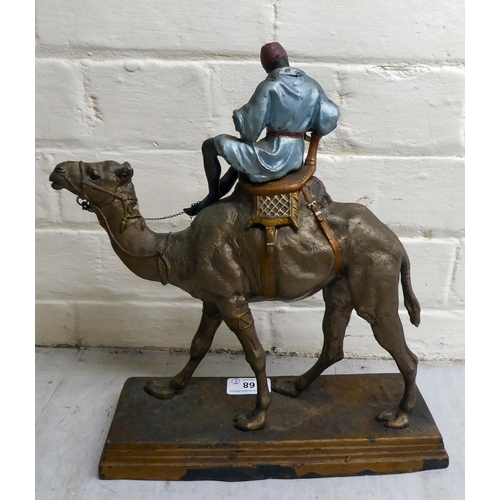 68 - A late Victorian painted spelter model, a man riding a camel  12