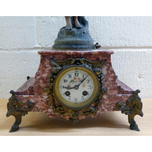 70 - A late Victorian mottled red marble mantel clock, surmounted by a spelter female figure; the 8 day m... 