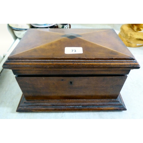 73 - A late Victorian mahogany jewellery box of sarcophagus form with a hinged lid, enclosing a tray fitt... 