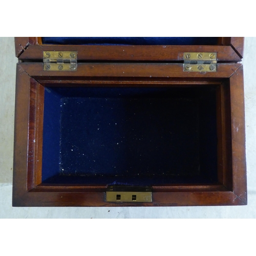 73 - A late Victorian mahogany jewellery box of sarcophagus form with a hinged lid, enclosing a tray fitt... 