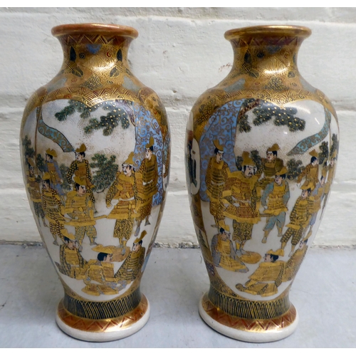 79 - A pair of 20thC Japanese earthenware vases, decorated with multiple figures  7.5