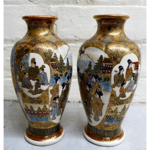 79 - A pair of 20thC Japanese earthenware vases, decorated with multiple figures  7.5