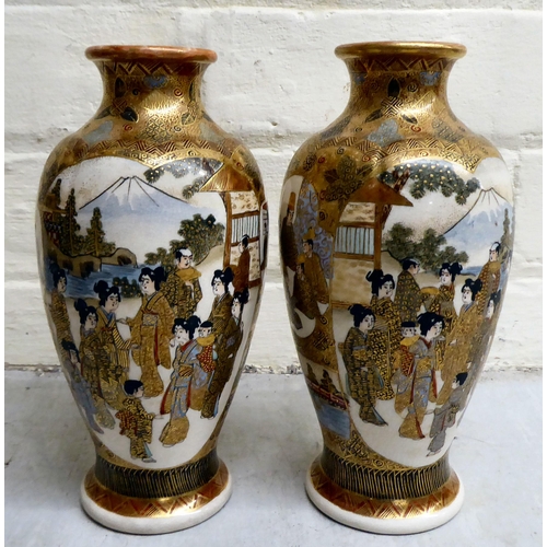 79 - A pair of 20thC Japanese earthenware vases, decorated with multiple figures  7.5