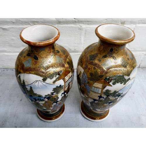 79 - A pair of 20thC Japanese earthenware vases, decorated with multiple figures  7.5