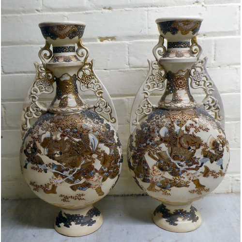 80 - A pair of early 20thC Japanese earthenware moon flask vases, decorated with warriors  19