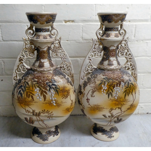 80 - A pair of early 20thC Japanese earthenware moon flask vases, decorated with warriors  19