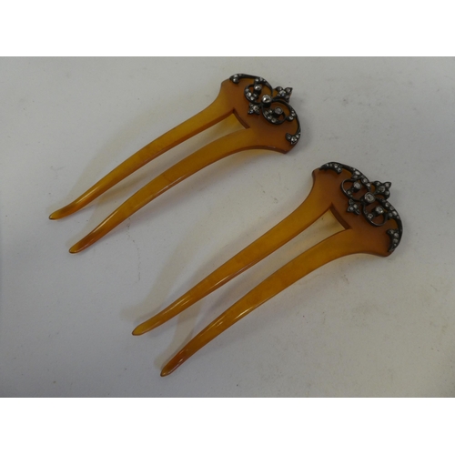 86 - A pair of early 20thC amber coloured resin hair slides, each set with diamonds