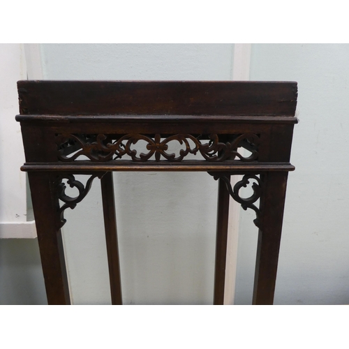 93 - A Georgian Chippendale inspired, mahogany kettle stand with a fretwork gallery, raised on rectangula... 