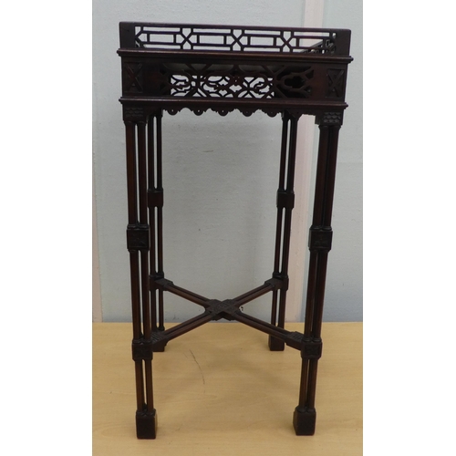 96 - An Edwardian Chippendale inspired mahogany kettle stand with a fretwork gallery, raised on rectangul... 