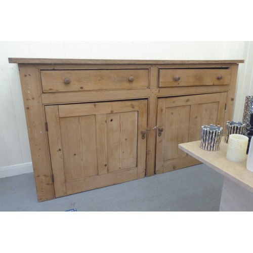 92 - A late Victorian pine dresser base with two drawers and two doors, on a plinth  36