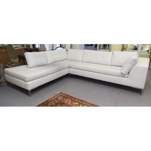 270 - A Dwell stitched white hide upholstered L-shaped, two piece settee, on a steel underframe  113