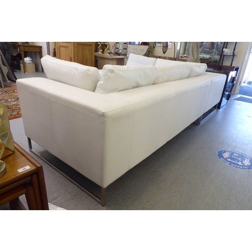 270 - A Dwell stitched white hide upholstered L-shaped, two piece settee, on a steel underframe  113