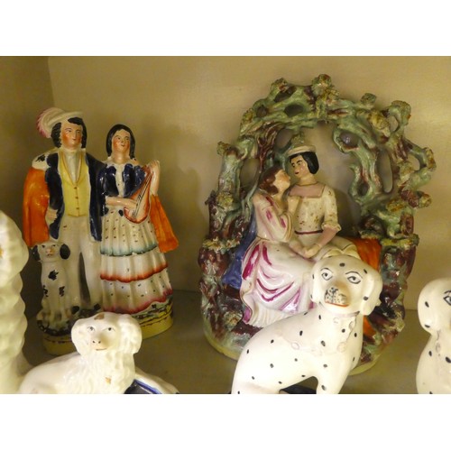 116 - Victorian Staffordshire pottery collectables: to include a man and woman, seated beneath an arbour  ... 