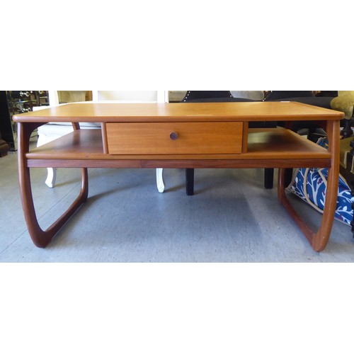 57 - A mid century Parker Knoll teak coffee table with a drawer and two open sections, raised on curved l... 