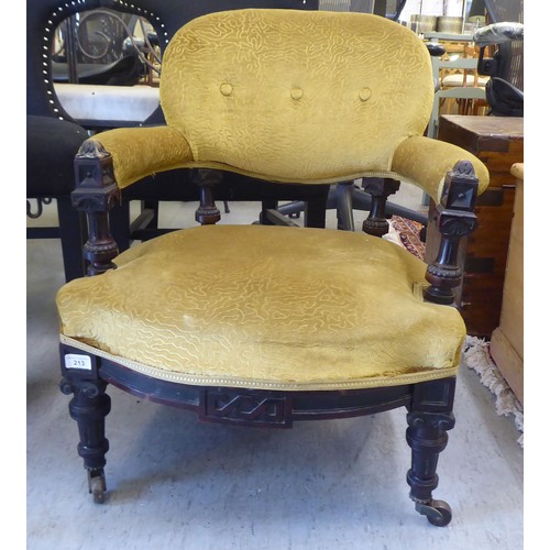 213 - A late Victorian oak showwood framed and later green fabric upholstered salon chair, raised on taper... 