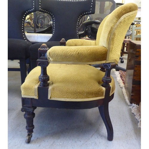 213 - A late Victorian oak showwood framed and later green fabric upholstered salon chair, raised on taper... 