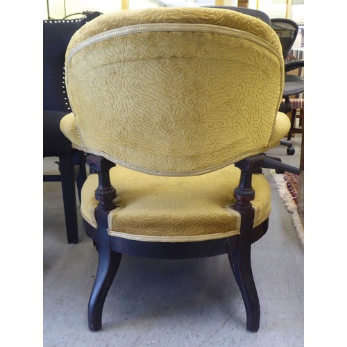 213 - A late Victorian oak showwood framed and later green fabric upholstered salon chair, raised on taper... 