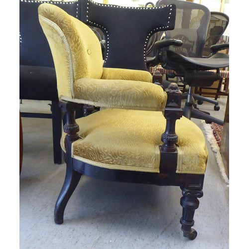 213 - A late Victorian oak showwood framed and later green fabric upholstered salon chair, raised on taper... 