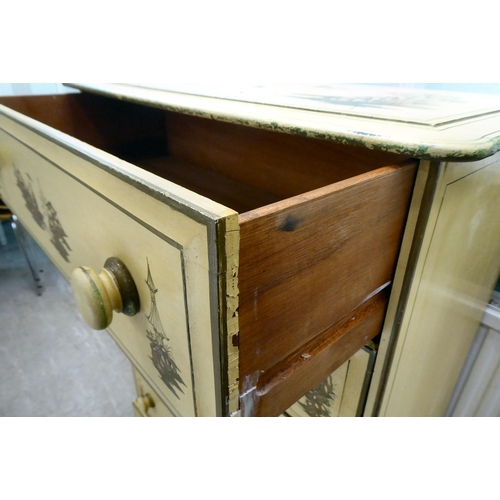 232 - A 20thC Orientally inspired cream painted and stencil decorated, seven drawer dressing chest, raised... 