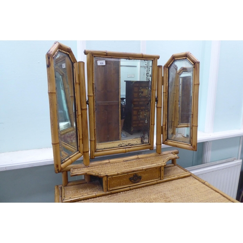 235 - A post World War II Oriental style bamboo and rattan finished dressing table, surmounted by a tripty... 