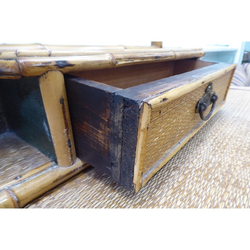 235 - A post World War II Oriental style bamboo and rattan finished dressing table, surmounted by a tripty... 