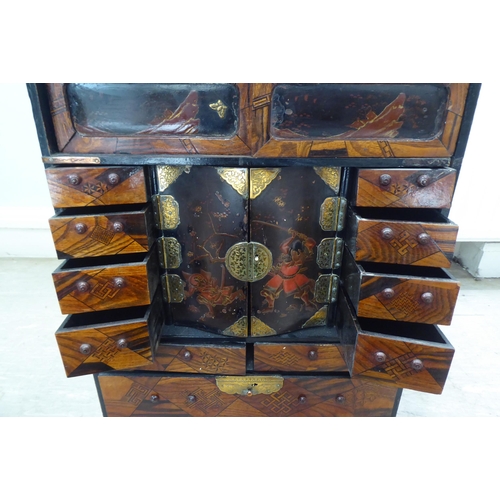 237 - A 20thC Japanese black painted and fruitwood marquetry inlaid table top cabinet with an arrangement ... 